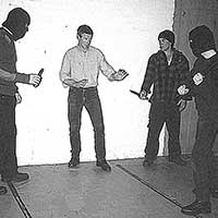 Instructor supervising a self-defence training exercise